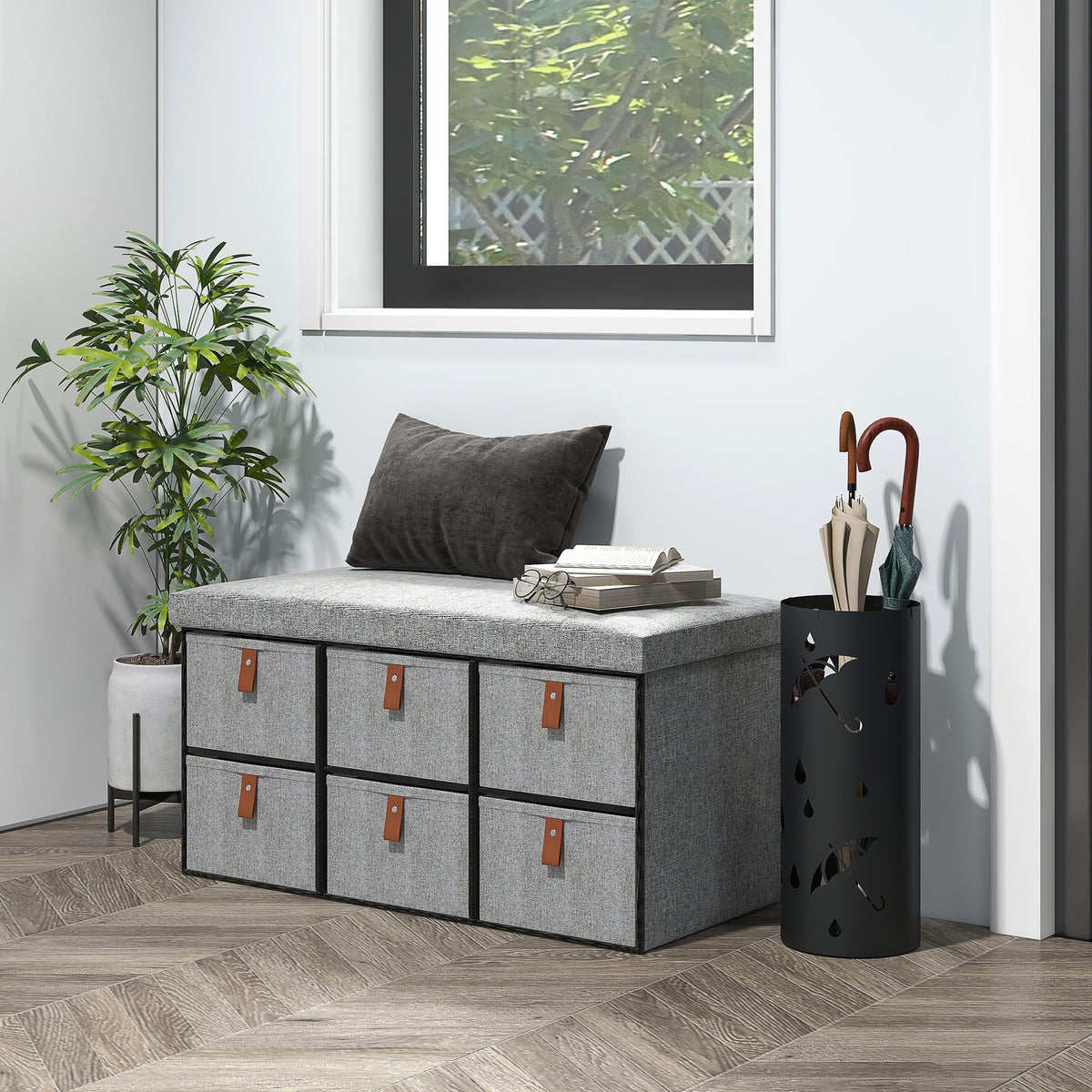 The shoe storage bench placed in a bright hallway next to a plant and umbrella stand