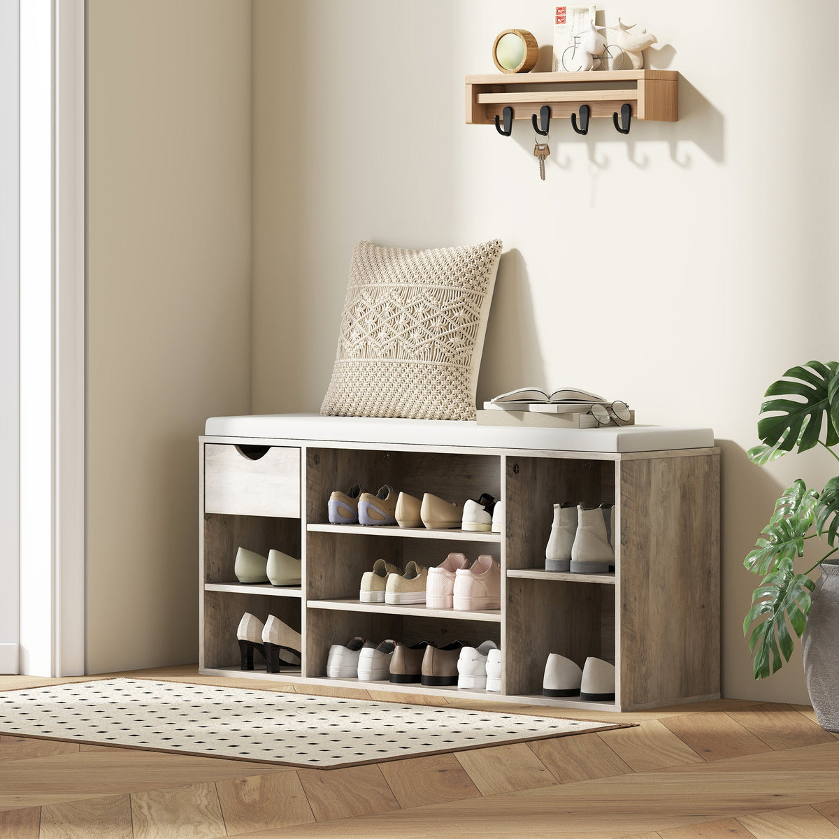 The shoe storage bench with cushion in a hallway with shoes and accessories