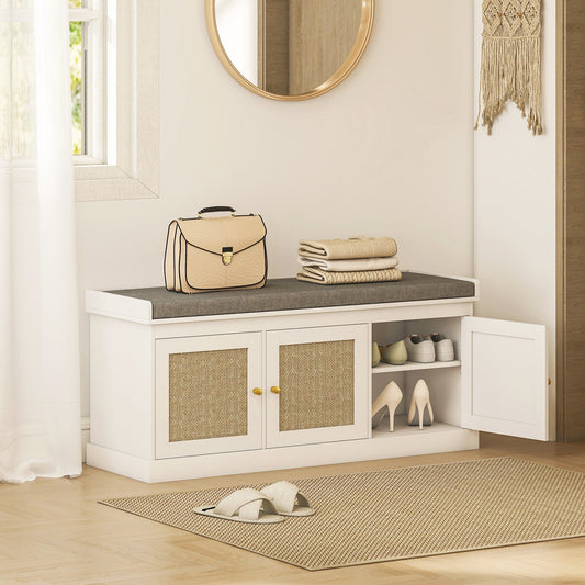 The shoe storage bench placed in a hallway with shoes and a bag on the grey padded seat