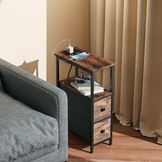 The narrow bedside table placed next to a grey sofa with a phone charging on the top shelf
