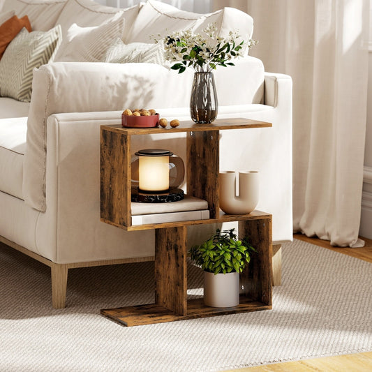 The narrow end table in a living room, placed next to a sofa with a lamp and plant on it