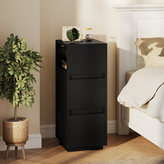The narrow bedside cabinet in a bedroom next to a bed with a plant beside it