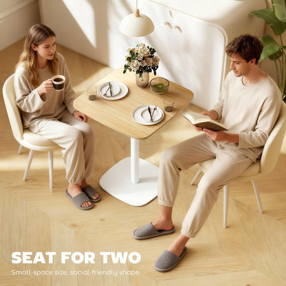 Couple enjoying coffee at the small dining table, highlighting its social use