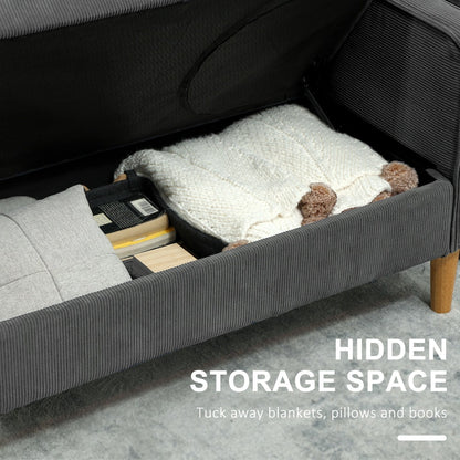 The grey corduroy sofa with its seat lifted to reveal hidden storage space for blankets and books