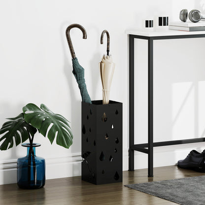 The steel umbrella stand holding two umbrellas in a hallway setting
