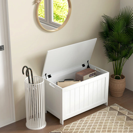 The white wooden toy box in a hallway, with an umbrella stand and a plant nearby