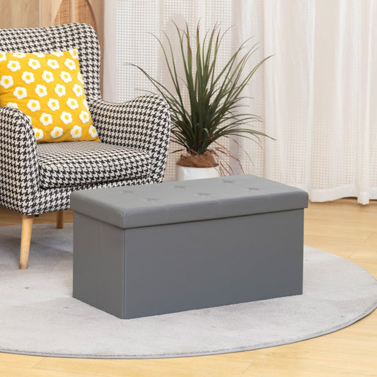 The storage ottoman bench in a living room setting next to an armchair