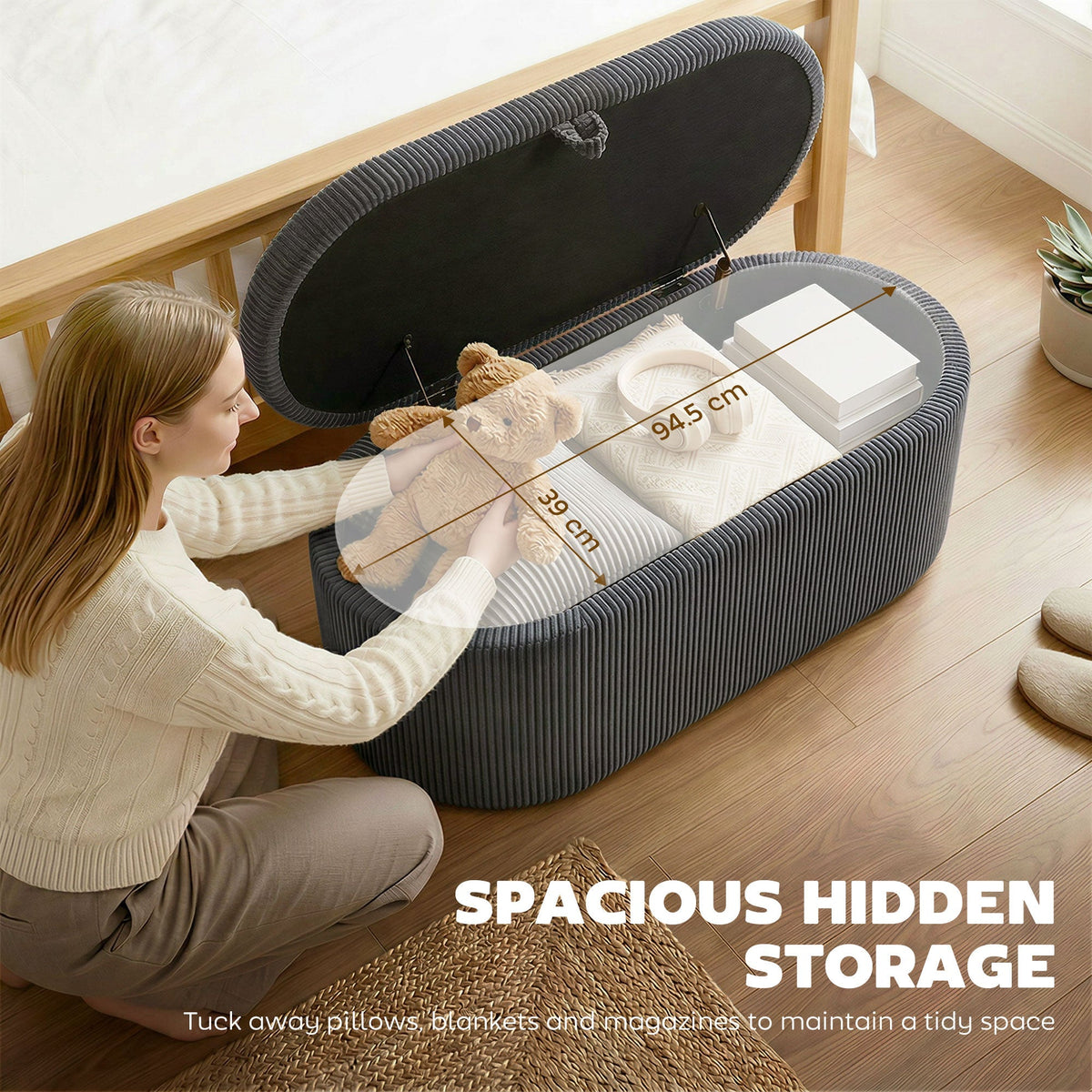 woman placing items into the open dark grey corduroy storage ottoman