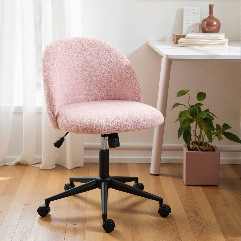The light pink teddy fleece office chair with wheels placed in a modern home office setting