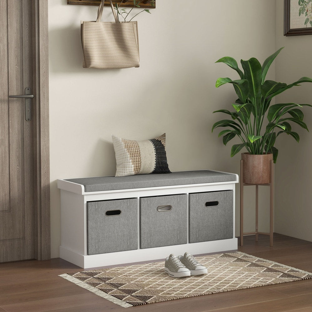 The shoe storage bench with padded top seat is shown in a hallway setting with a bag hanging above and shoes on the floor