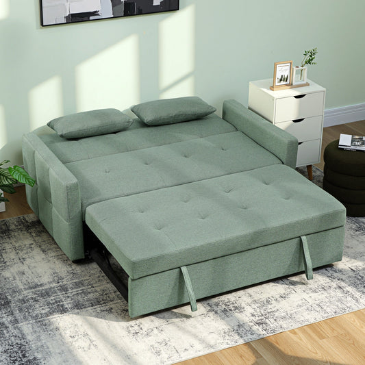 The green sofa bed pulled out into a bed with two pillows