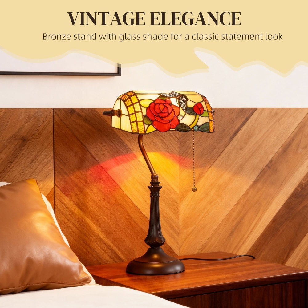 The Tiffany-style rose and butterfly table lamp providing warm light on a bedside table