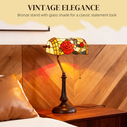 The Tiffany-style rose and butterfly table lamp providing warm light on a bedside table