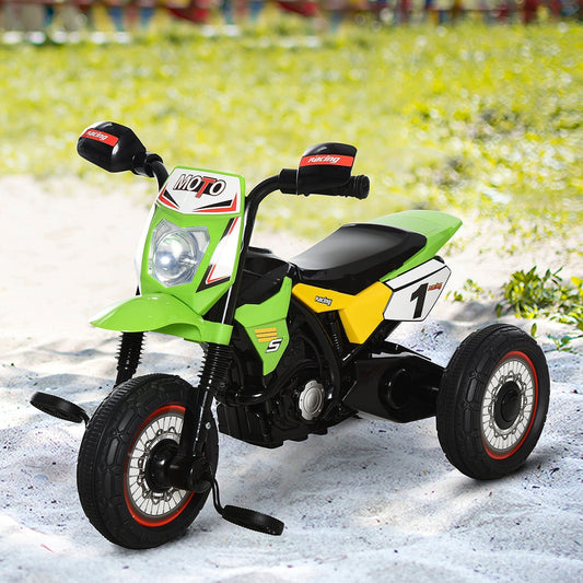 The kids pedal motorbike parked on a sandy surface in an outdoor setting