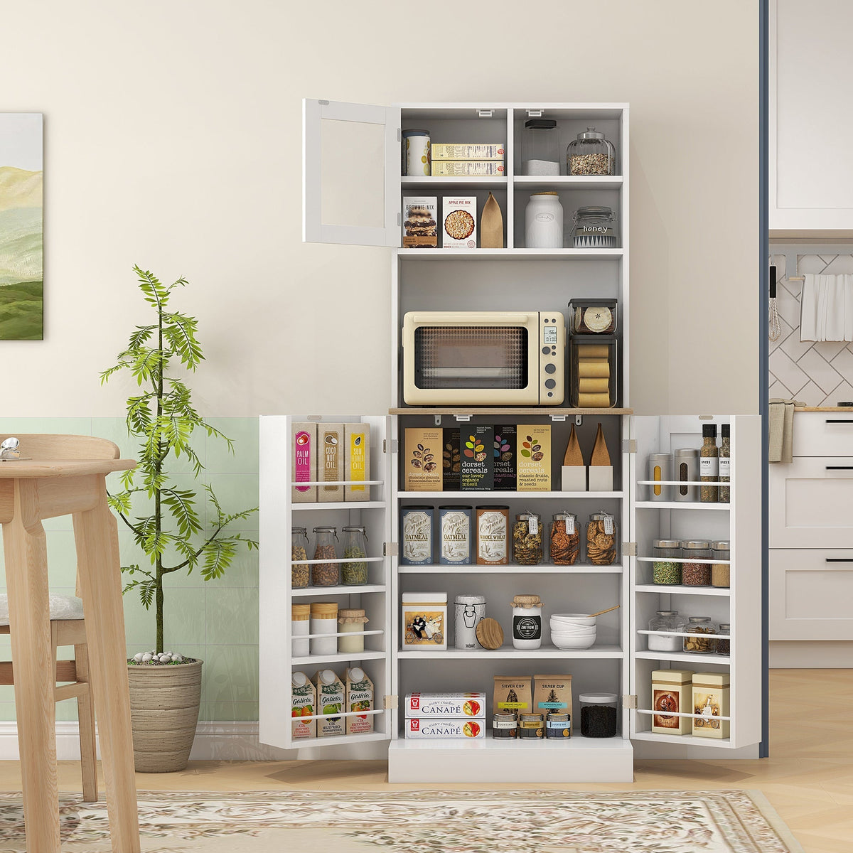 The kitchen furniture filled with various food items and a microwave in a dining room setting