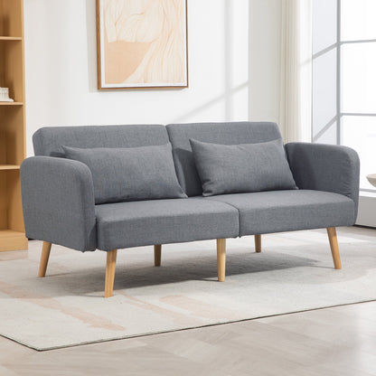 The grey fabric sofa bed is shown in a living room setting with two pillows on top