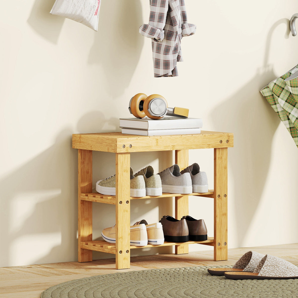 The bamboo shoe rack in a hallway, holding shoes on its shelves and a few books on top