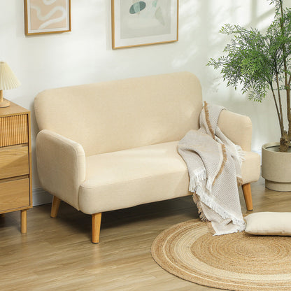Cream white two seater sofa in a living room setting with a throw blanket
