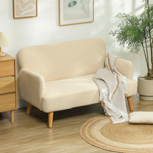 Cream white two seater sofa in a living room setting with a throw blanket