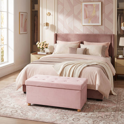Pink velvet ottoman footrest in a bedroom setting
