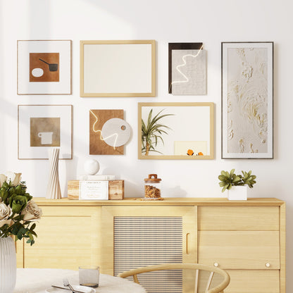 The wall mirror displayed as part of a gallery wall arrangement above a wooden sideboard