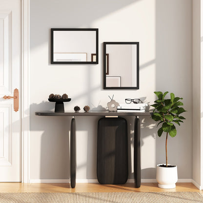 Two black framed wall mirrors hanging on a wall in a hallway with a console table