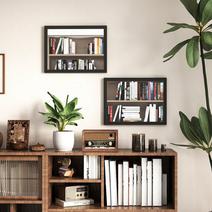 Two black framed wall mirrors hanging above a wooden cabinet with books and plants
