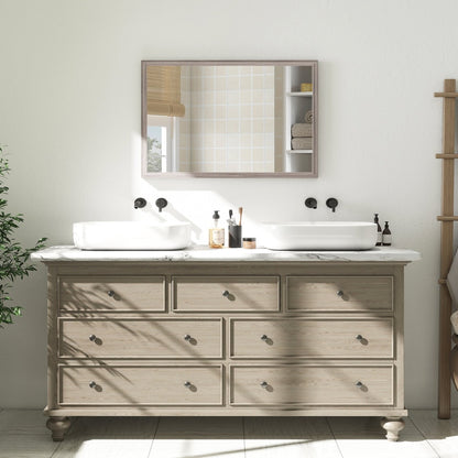 The wall mirror is shown above a wooden dresser with white sinks