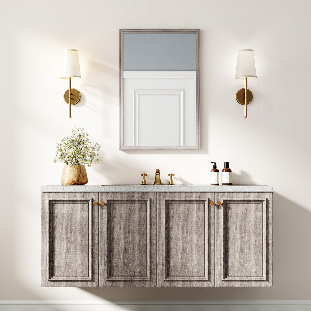 The wall mirror is shown above a grey vanity unit with wall lights
