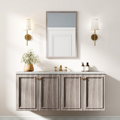 The wall mirror is shown above a grey vanity unit with wall lights