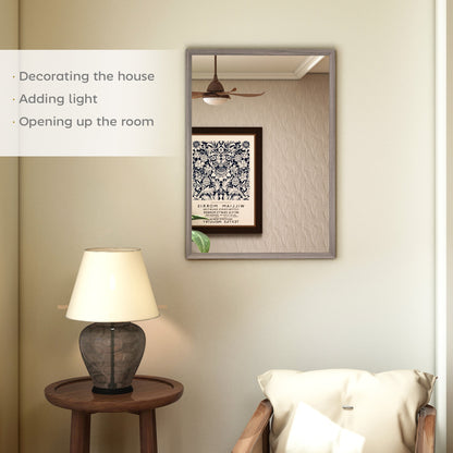 The wall mirror is shown in a living room setting, reflecting a lamp and chair