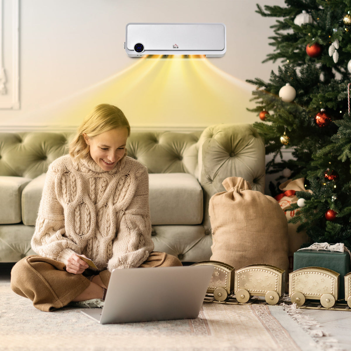 The electric space heater mounted on a wall above a woman sitting on the floor in a living room