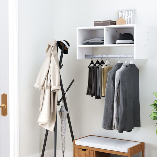 The wall mounted coat rack with shelf is shown in a hallway with coats and hats hanging