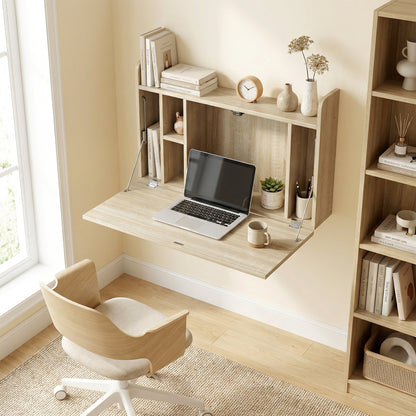 The office desk mounted on a wall with the drop leaf open and a laptop placed on the surface