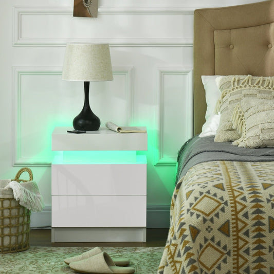 The white bedside table with LED light is shown in a bedroom setting next to a bed
