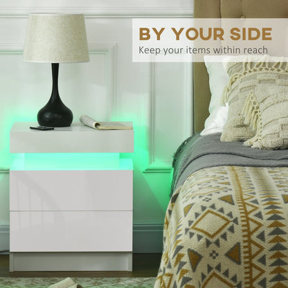 This white bedside table with LED light is shown next to a bed, keeping items within reach