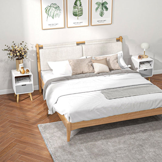 Two wooden bedside tables in a bedroom setting next to a bed