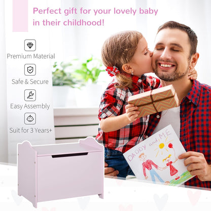 A father and child present a drawing next to the pink toy chest
