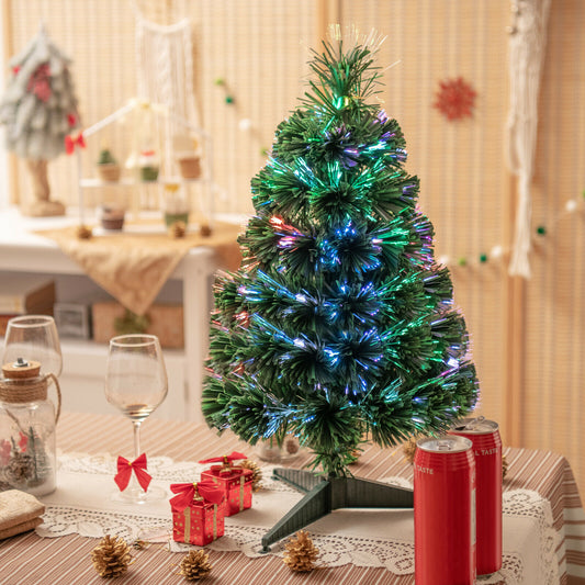 The fibre optic Christmas tree lit up on a table with gifts and drinks