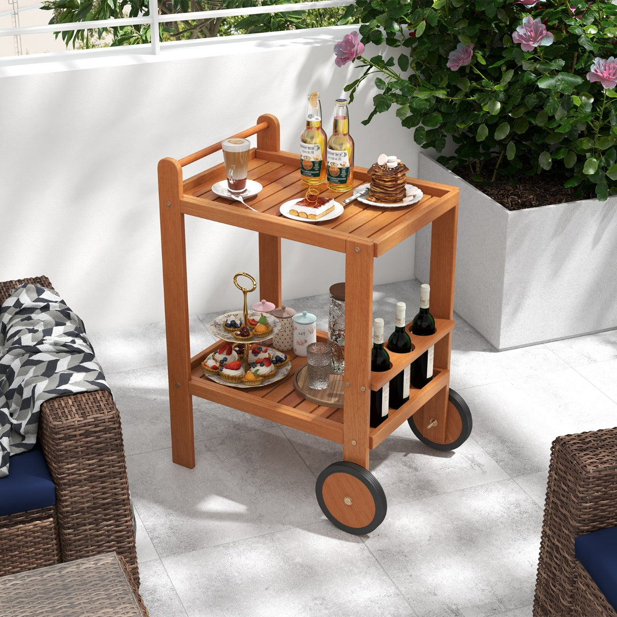 The wooden bar cart displaying desserts and drinks on a sunny patio terrace