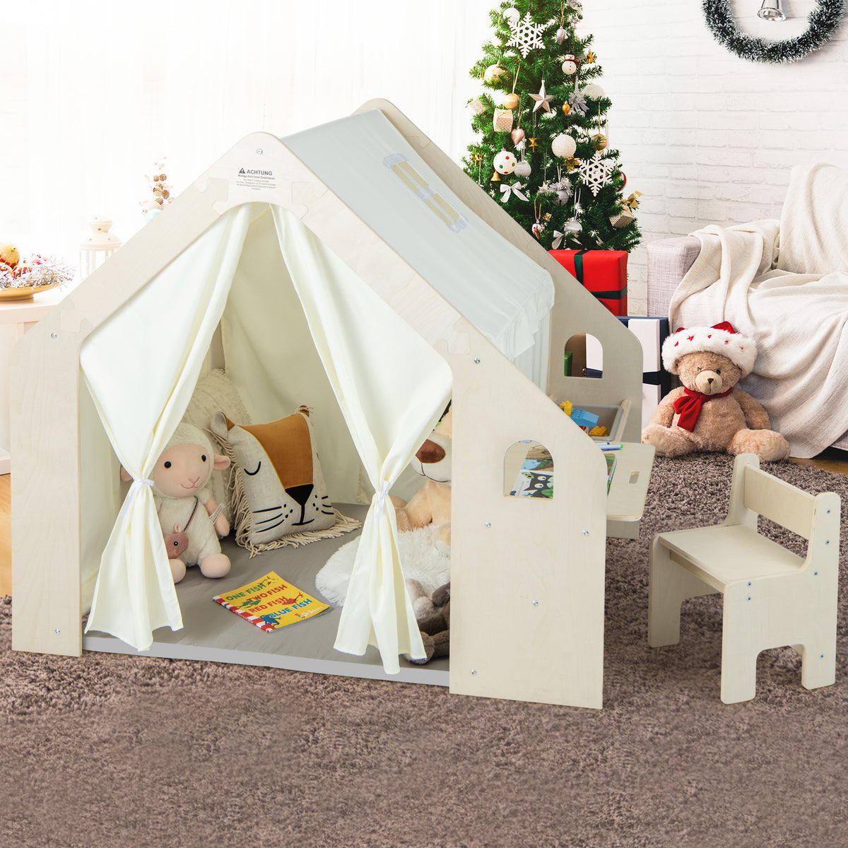The wooden playhouse with fabric roof and curtains standing on a carpeted floor