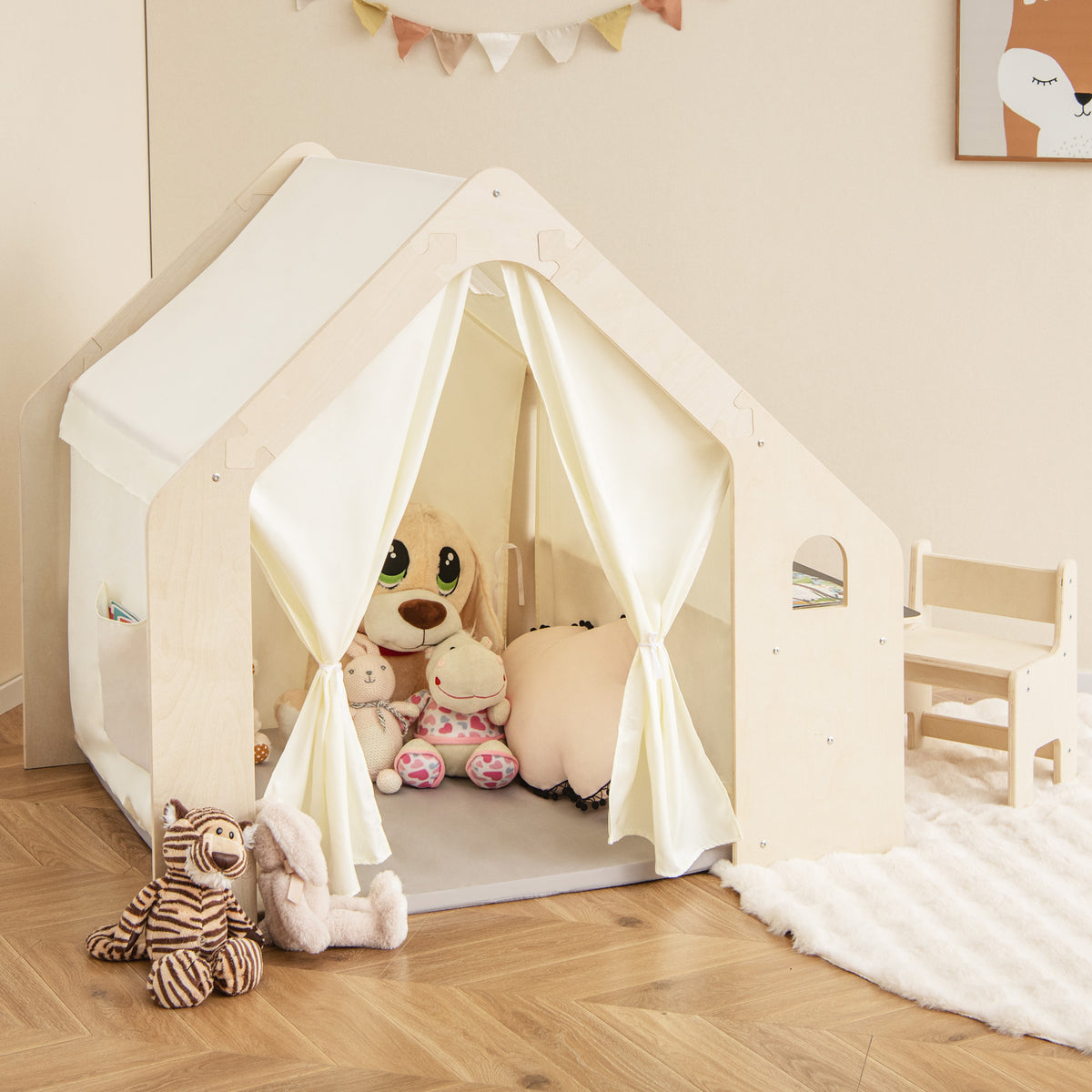 The wooden playhouse with curtains tied back and a matching chair on a rug