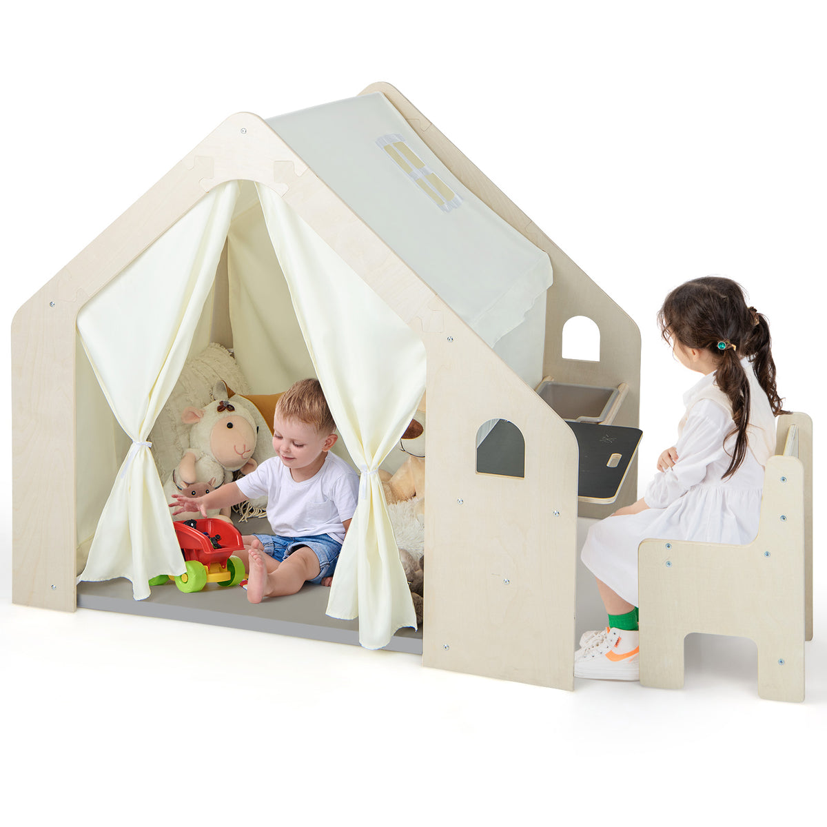 The wooden playhouse with a grey floor mat and a side storage compartment