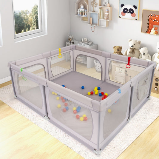 The light grey baby activity center shown assembled on a rug with ocean balls inside