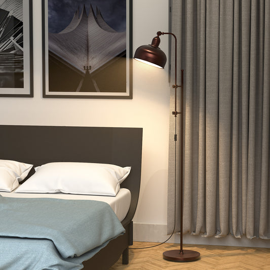 the metal floor lamp standing on a wooden floor next to a bed with a lit dome shade