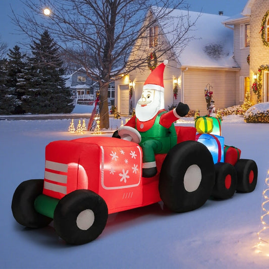 The inflatable Santa Claus driving a tractor in a garden at dusk, illuminated by LED lights