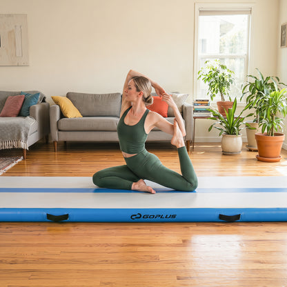 The gymnastic mat placed in a living room with a woman doing a yoga pose on it