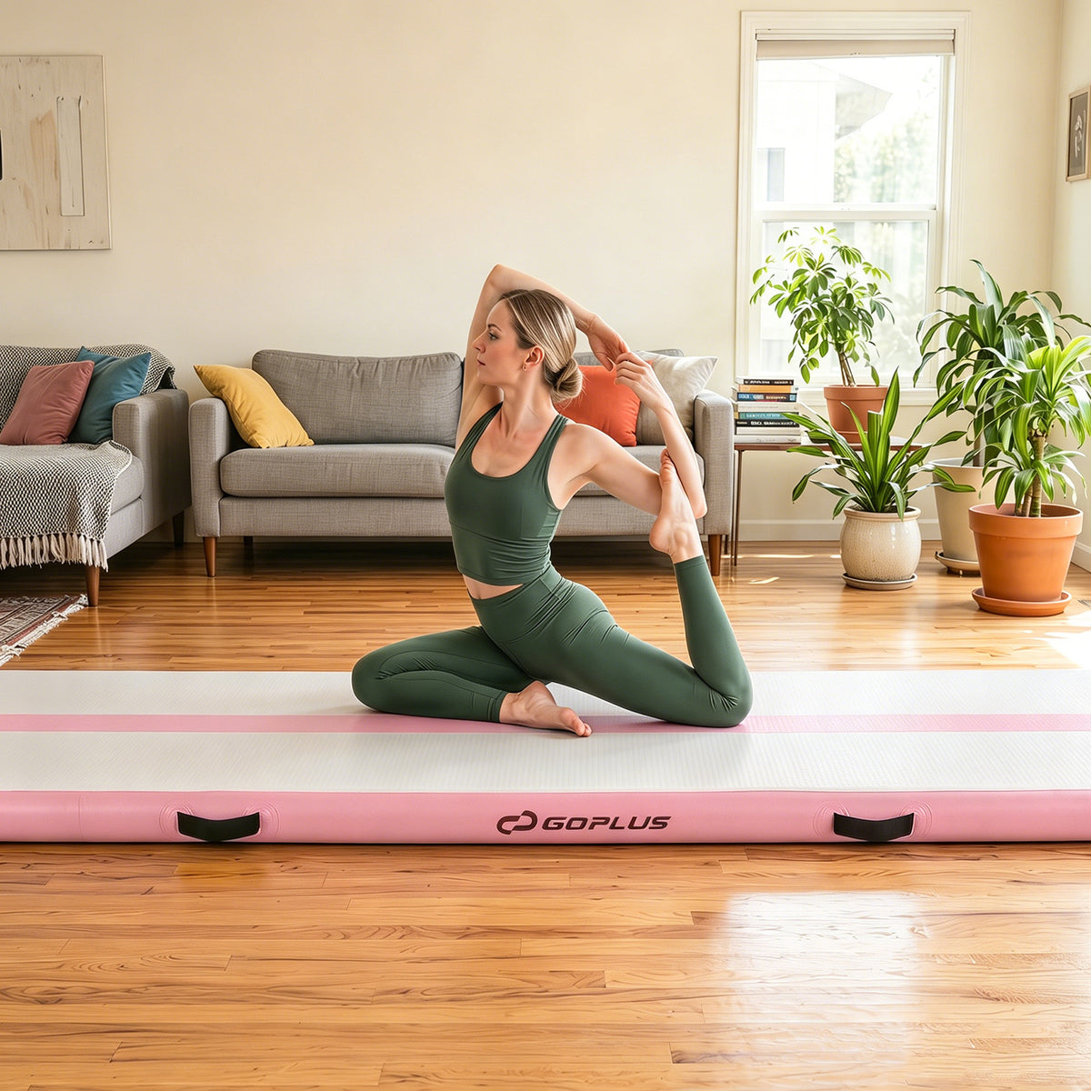 The pink tumbling mat laid out on a wooden floor in a bright living room