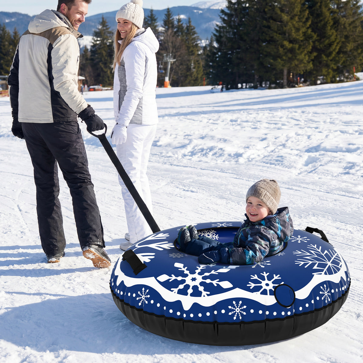 A family using the inflatable snow tube for sledding down a snowy hill