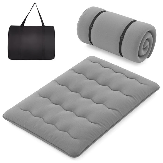Japanese Floor Mattress laid out flat with a rolled up mattress and a carry bag beside it